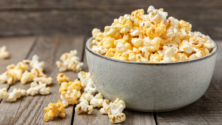 A bowl of popcorn, spilling over