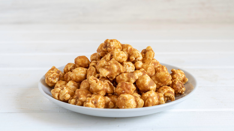 A plate full of peanut butter popcorn sits on a table