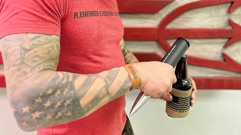 Person opening bottle with large opener