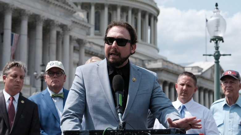 Eli Crane speaks outside government building