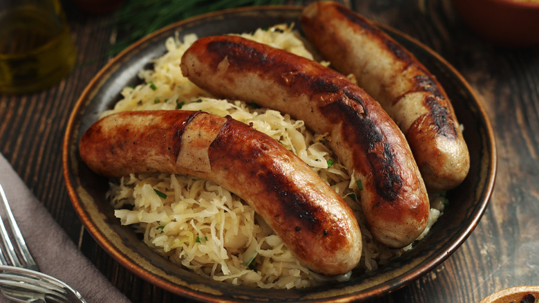 A bowl of bratwurst and sauerkraut.