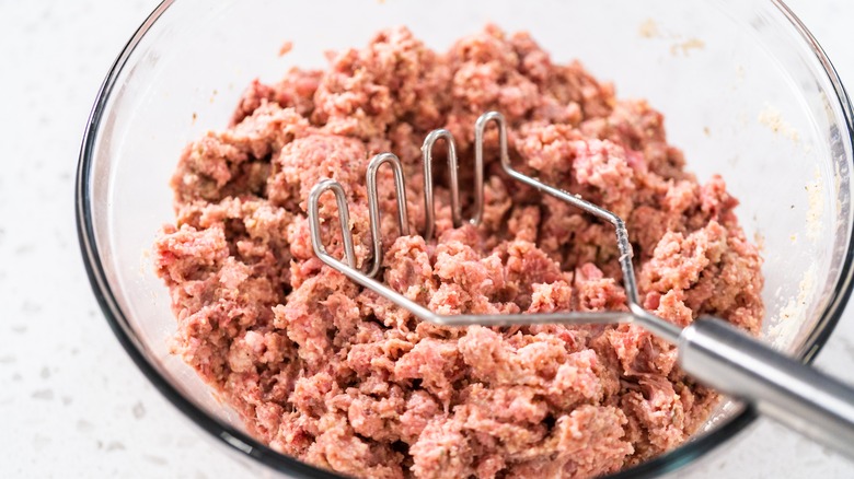 A potato masher on white background
