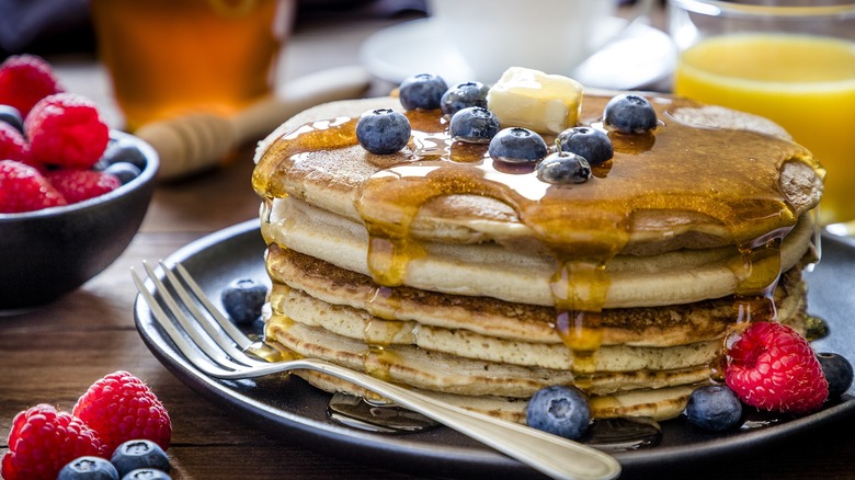 Stack of pancakes with blueberries and raspberries