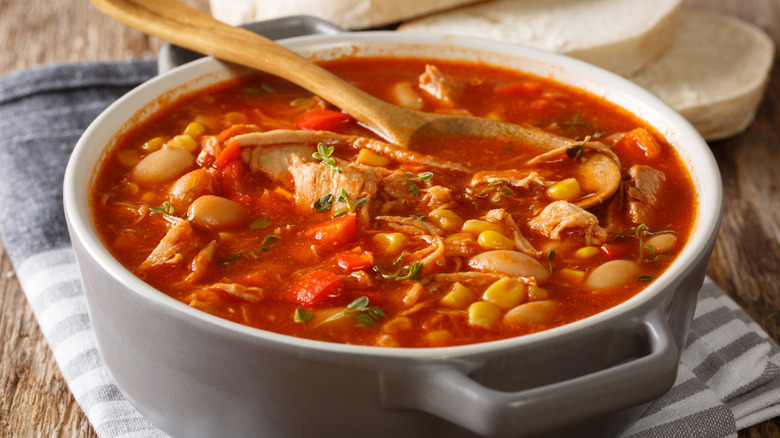 A pot of Brunswick stew with pulled meat and barbecue sauce