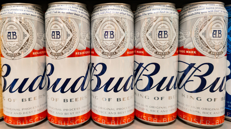 Budweiser cans sold on a shelf.