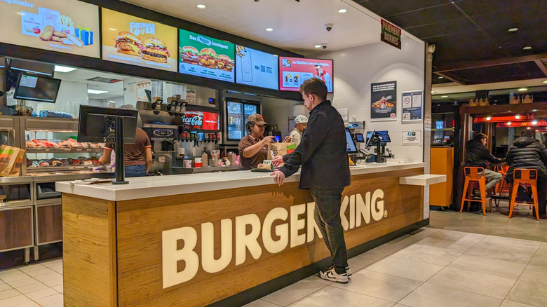 A man orders at a Burger King counter