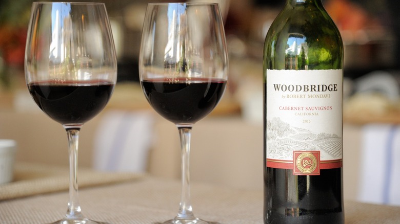 Cabernet sauvignon bottle next to wine glasses.