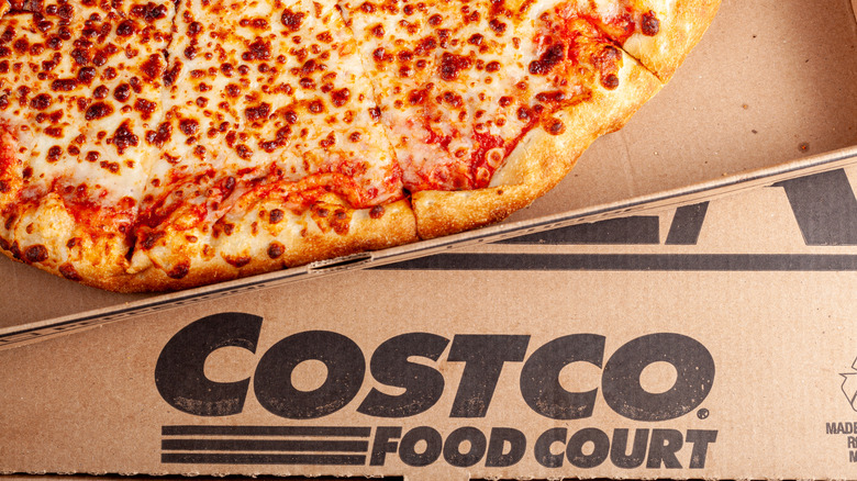 Costco cheese pizza on a box with a black Costco Food Court label