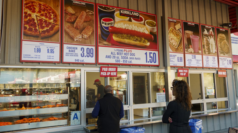 Customers waiting in line at an outdoor Costco food court