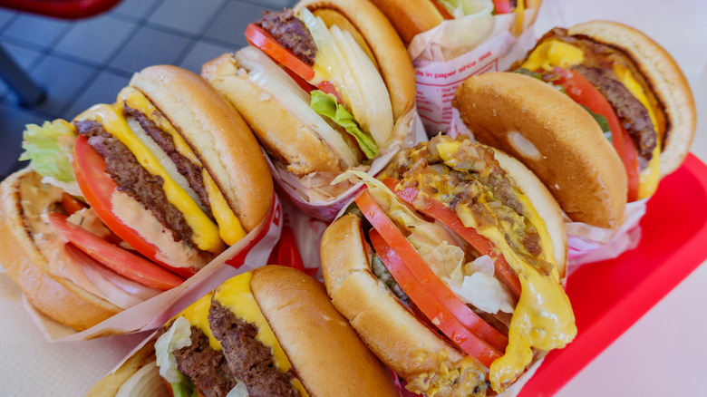 Various In-N-Out burgers on a red tray.