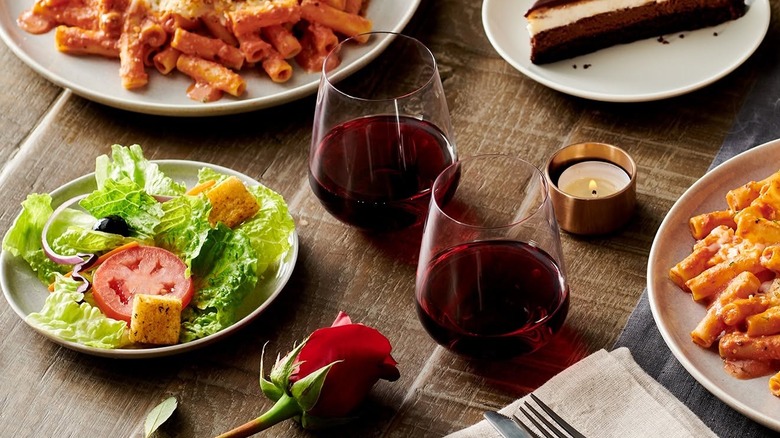 Olive Garden dishes and wine on a table.