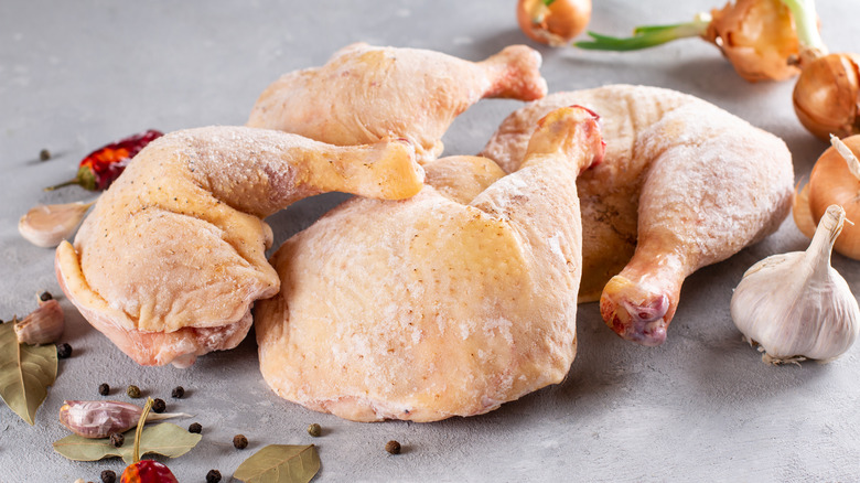 frozen chicken surrounded by garlic and spices