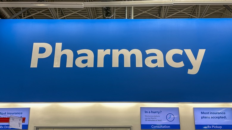 A Sam's Club Pharmacy sign, printed in white text on a blue background