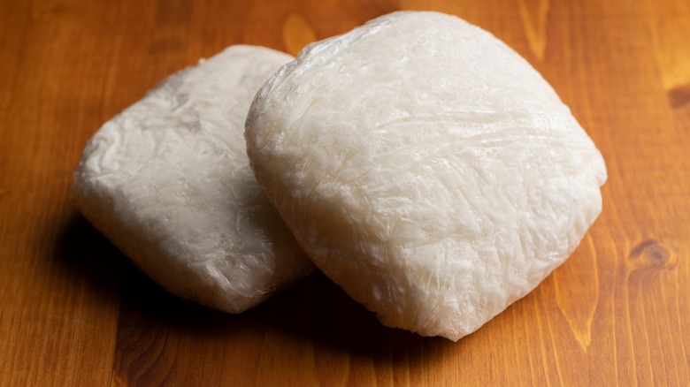 white rice portioned in individual plastic wrap bundles