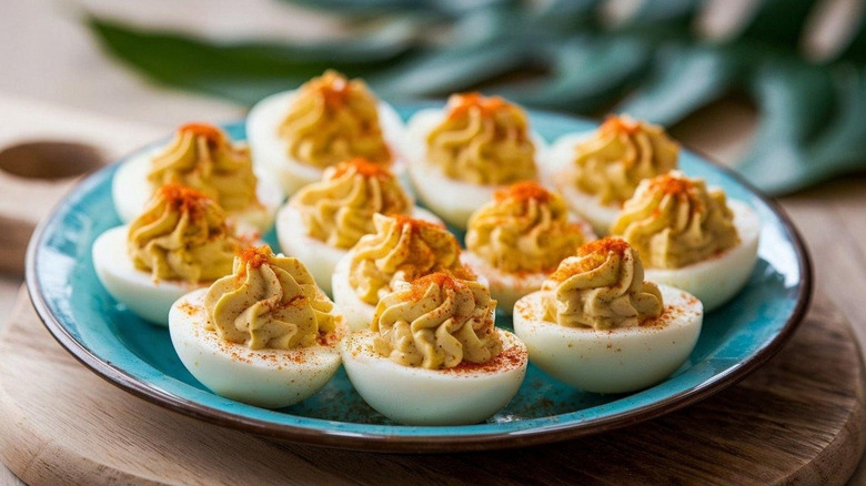A plate of deviled eggs dusted with paprika