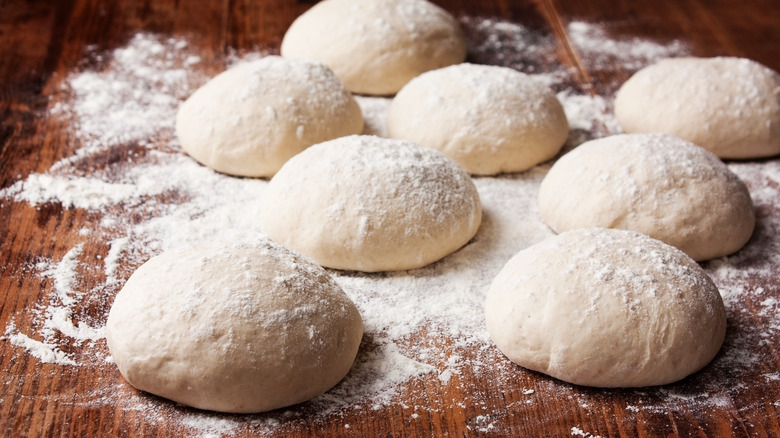 balls of pizza dough on table