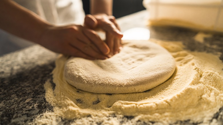 Person stretching dough
