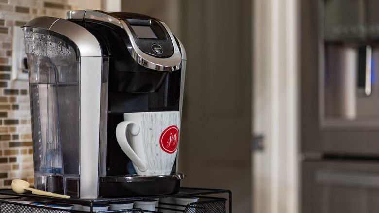 A Keurig coffee maker with a mug