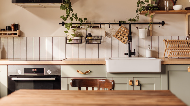 A modern, wooden kitchen countertop with sink and stove