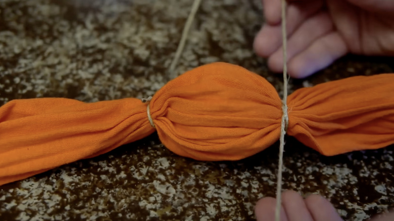 An egg tied inside a long-sleeved tee-shirt