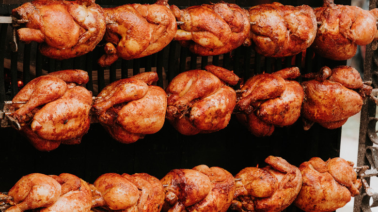 Three rows of five rotisserie chickens