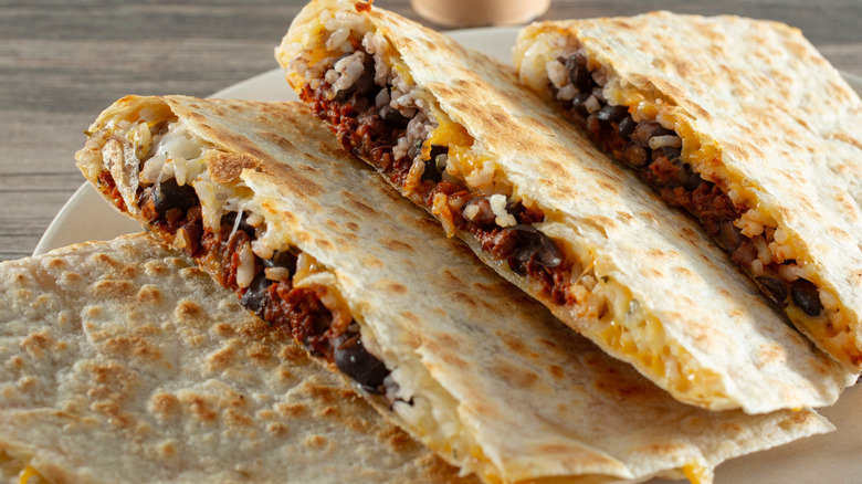 Four pieces of sliced vegan quesadillas with melty vegan cheese.