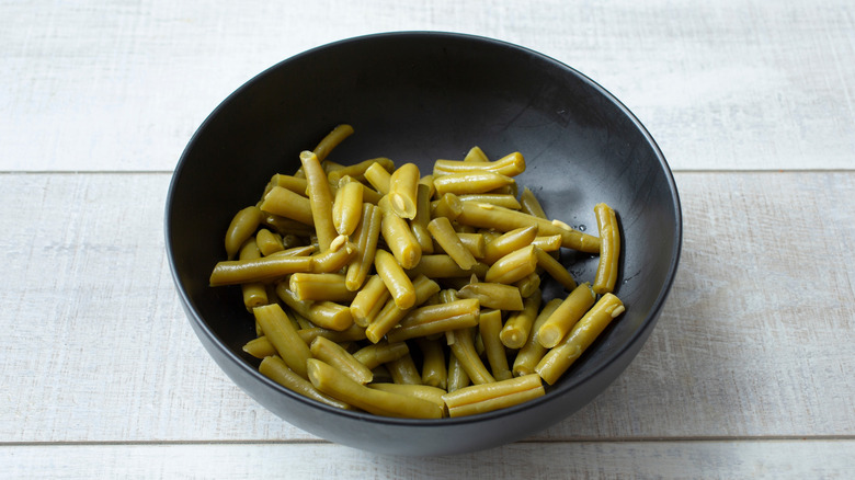 A bowl of decanted canned green beans.