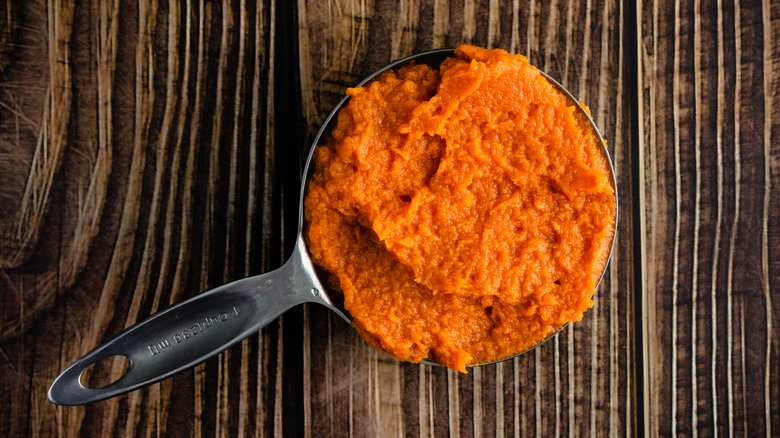 measuring cup of pureed pumpkin
