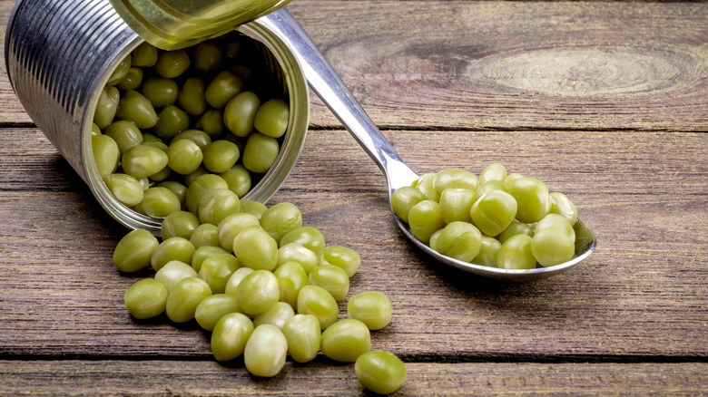 Peas spilling from a can.