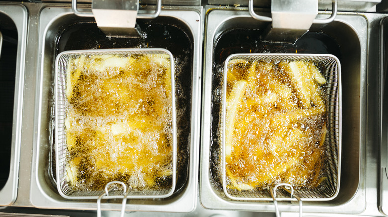 French fries fry up in a fryer filled with oil