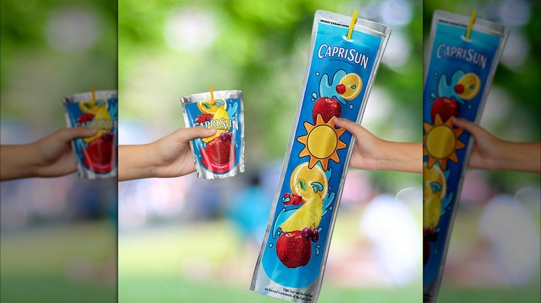 An extra-long Capri Sun pouch is held next to a regular-sized pouch
