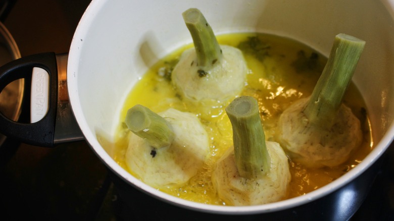 artichokes cooking in pot