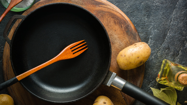 Cast iron cookware and a potato