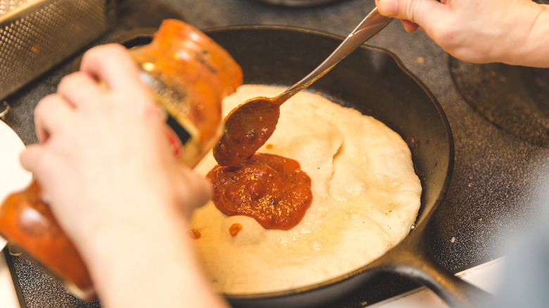 Making pizza in cast iron skillet
