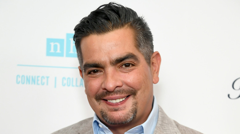 Aarón Sànchez in front of step and repeat