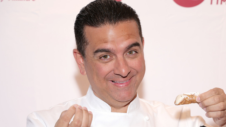 Buddy Valastro posed in front of Carlo's Bakery step and repeat