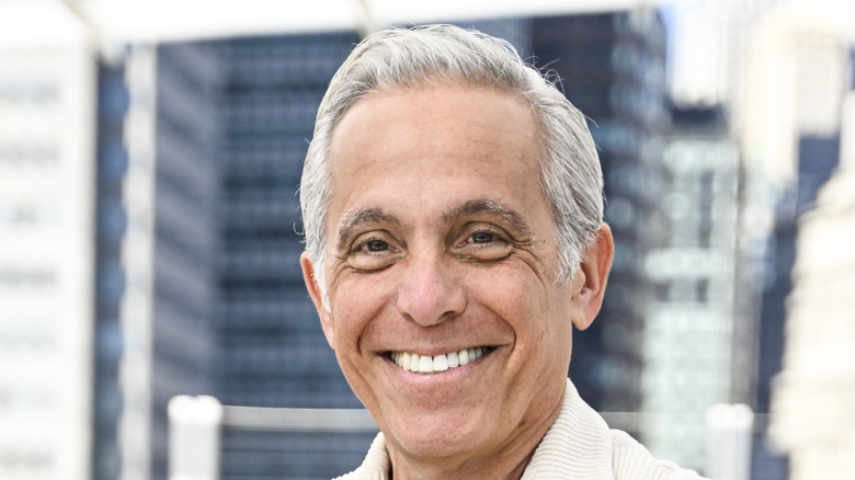 Geoffrey Zakarian posed outdoors in front of buildings