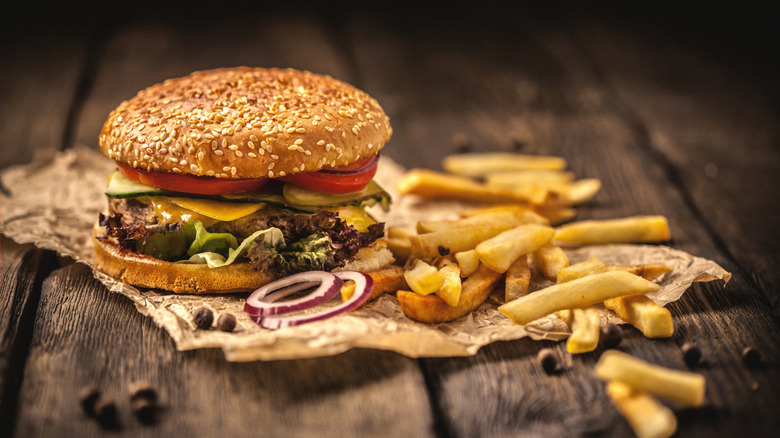 Burger and fries on wooden table