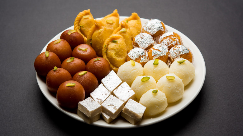 Variety of mithai on white plate