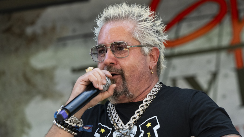 Chef Guy Fieri holding a microphone