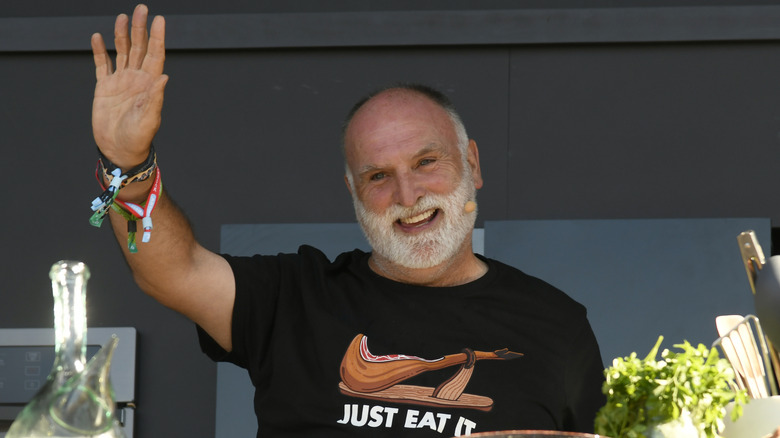 Chef José Andrés waves to the crowd during an outdoor cooking demonstration