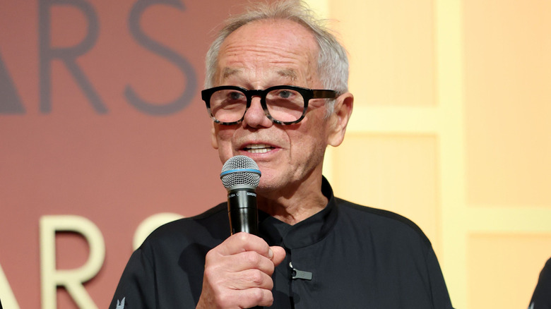 Wolfgang Puck holding microphone