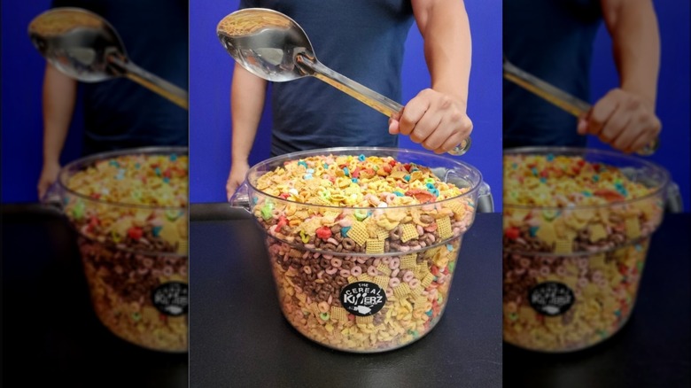 Person holding a spoon over a Cereal Challenge bowl