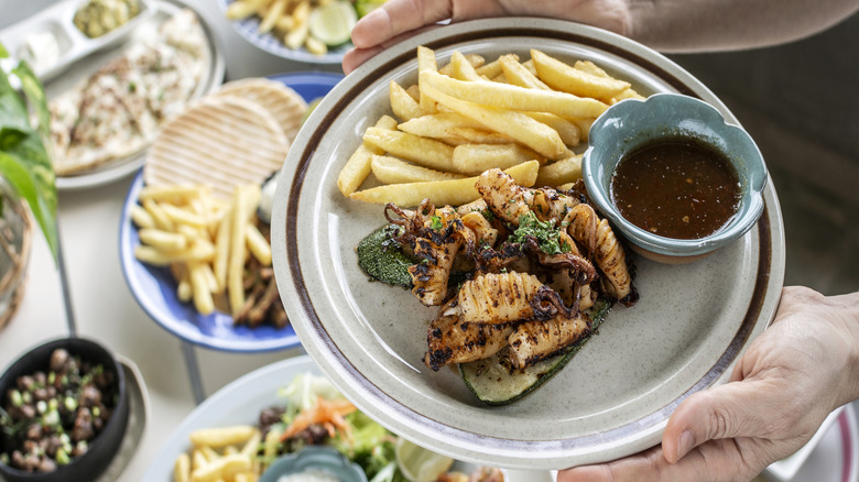 Squid escabeche on a plate with fries