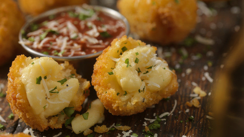 Fried mac and cheese pieces on wood background