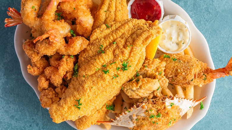 The Pappadeaux Seafood Platter sitting on a plate with fried catfish, shrimp, and stuffed crab visible from Pappadeaux Seafood Kitchen.