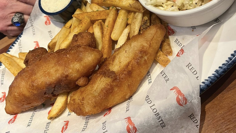 Fish and chips with coleslaw and tartar sauce sitting in a basket from Red Lobster