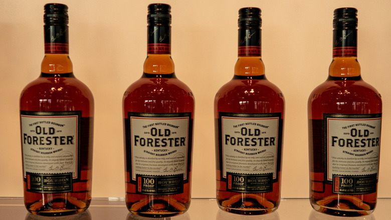 Bottles of Old Forester 100 Proof on display shelf
