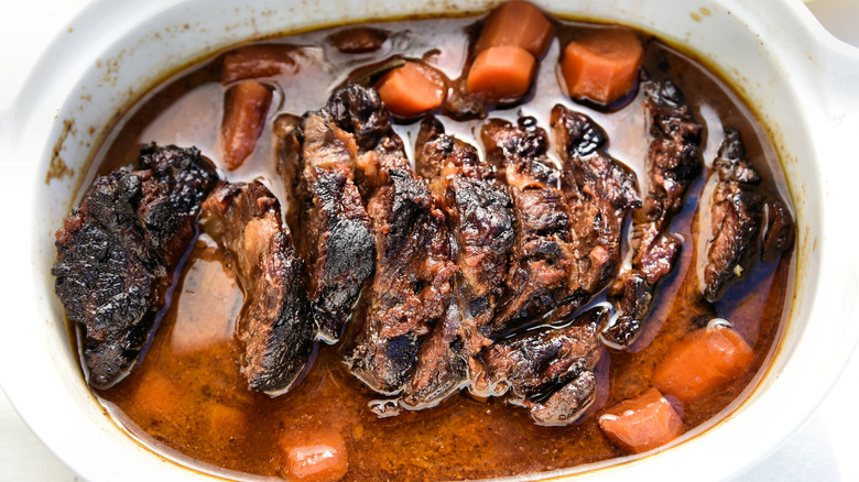braised sliced brisket with carrots and braising liquid