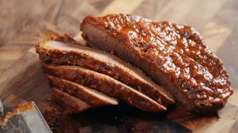 cooked brisket slices on a cutting board